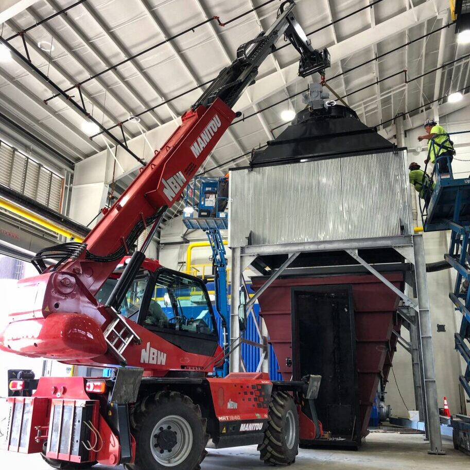 A NBW Crane lifting a unit. NBW Inc.