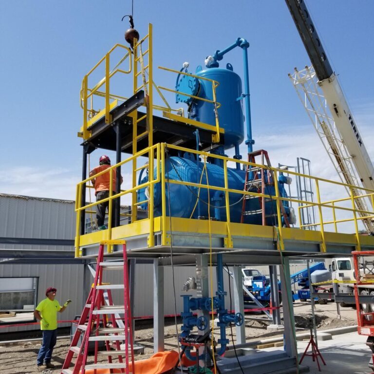 A crane lifting a boiler unit. NBW Inc.