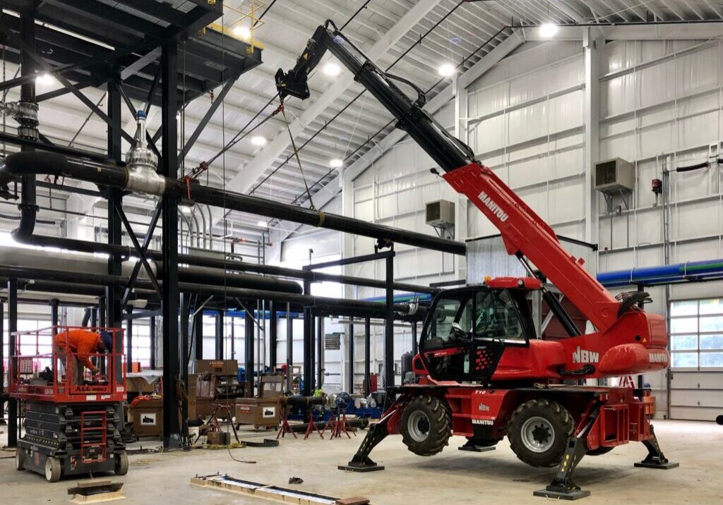 NBW crane lifting a pipe. NBW Inc.